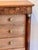 A neat little Empire chest with five drawers, flanking columns with brass capitals and bases, and a burr walnut frieze...