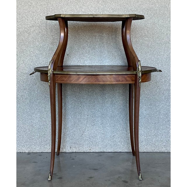 A charming French 19th century Louis XVI style side table in mahogany. The table is raised on cabriole legs. The table has...