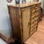 A faux bamboo nightstand by Stanley Furniture, circa 1970s. Two cabinet doors fronted in woven cane with Greek key...