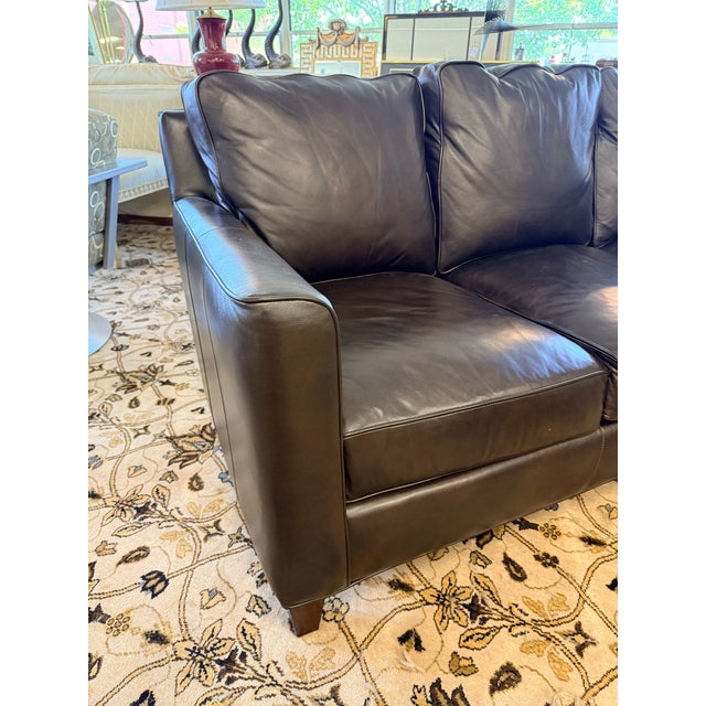 Handsome Bradington Young three‑cushion sofa, upholstered in a rich chocolate brown premium leather that reads warm,...