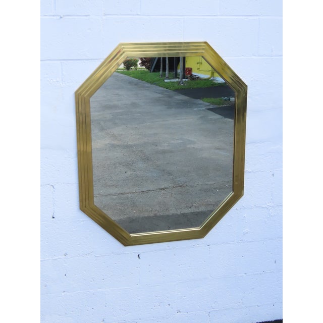 This vintage mirror is made out of metal and mirror. We believe the mirror was made by Willy Rizzo, however it is not...