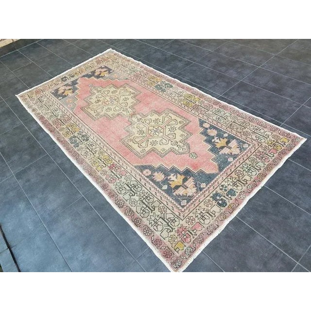 This is a vintage Turkish Oushak rug from the 1960s. The piece was hand-knotted.