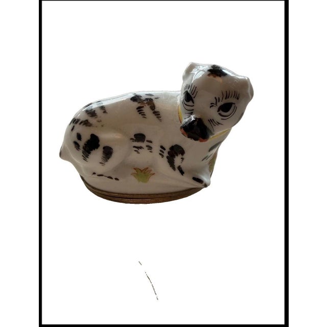 A charming pair of hand-painted Limoges porcelain trinket boxes, each modeled as a recumbent pug in the classic...