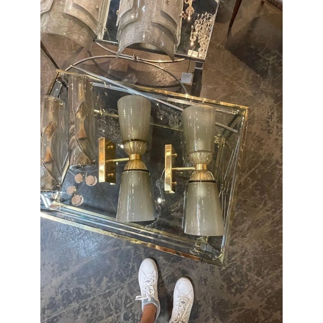 Lovely pair of modern Murano glass and brass double blown sconces. Very pretty cone shape with beautiful translucent and...