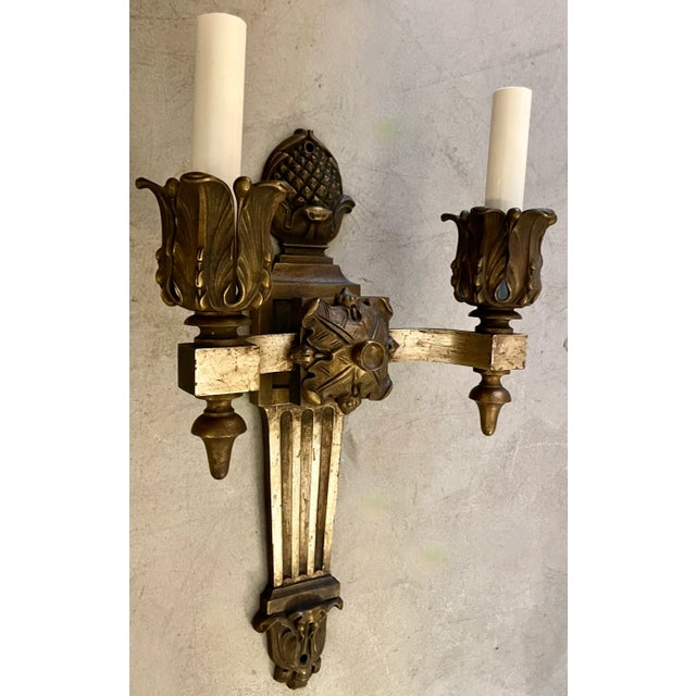 Large and heavy pair of wall sconces in a Neoclassical style. Circa 1960. Made of metal with an high quality design. Newly...
