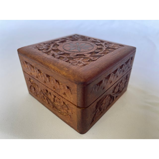 1970's Indian hand carved teak square jewellery box with brass inlaid flower at top center surrounded by floral design all...