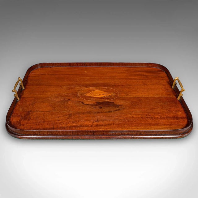 This is an antique serving platter. An English, mahogany afternoon tea tray crafted in Georgian revival taste, dating to...