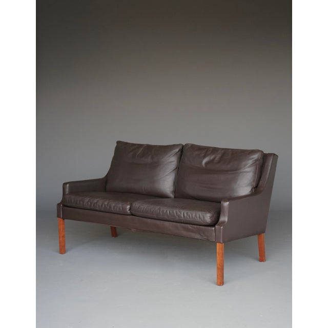 A stylish Danish design two seater sofa\. This sofa was designed by Georg Thames and has a chocolate brown leather...