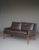 A stylish Danish design two seater sofa\. This sofa was designed by Georg Thames and has a chocolate brown leather...