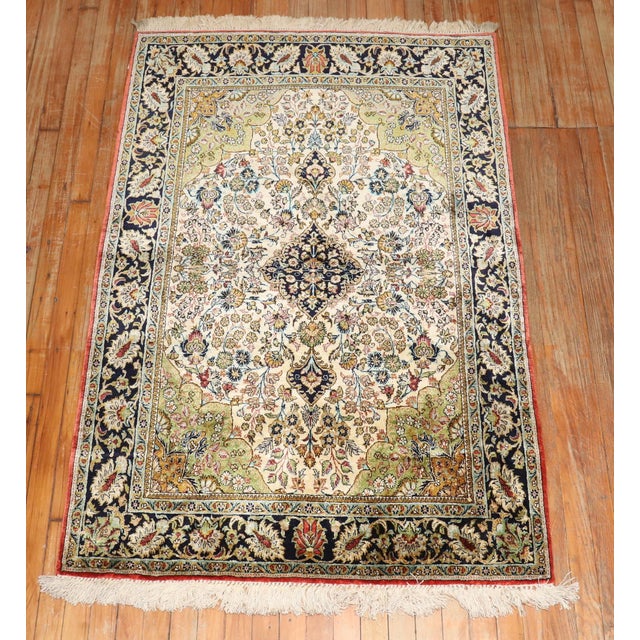A Silk Persian Qum rug from the 20th century. Measures: 3'7'' x 5'4''.