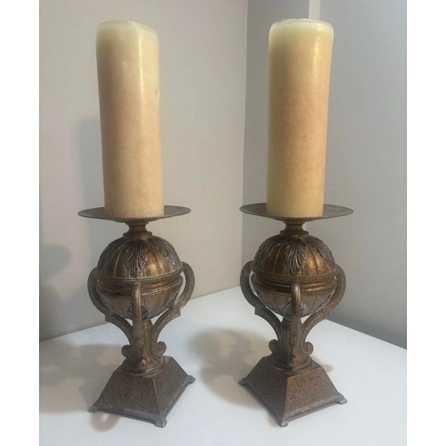 A substantial pair of vintage solid bronze urn-form candlesticks by Abel Casting, featuring classical side handles,...
