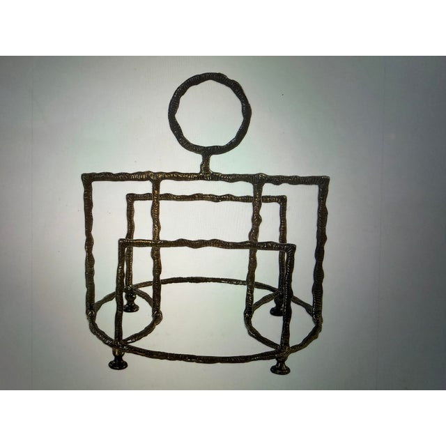 Thick cast iron, featuring a crude, organic shape, with a beaten texture surface, hand finished in a plated antique brass...