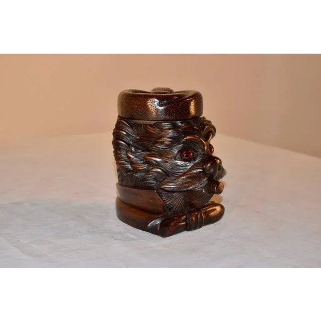 19th Century hand-carved humidor in the form of a dog's head. The dog is very whimsical with a hat, which lifts to reveal...