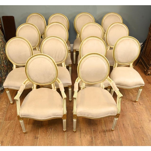 A superb and highly decorative set of fourteen french louis xvi style dining chairs, comprising 12 side chairs and two...