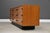 A mid century modern teak nine drawer dresser with a black plinth base and black finger pulls. Made in Canada. Circa...