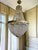 An absolute eye-catcher! This imposing Empire-style chandelier is richly finished with a beautifully engraved brass frame,...