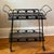 Offering a beautiful vintage Russell Woodard-Style wrought iron serving cart from the mid-20th century. This pretty...