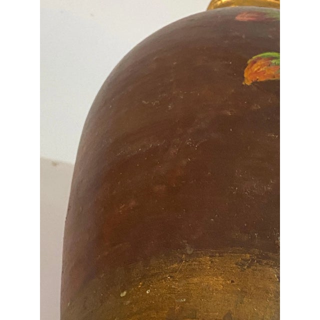 This jug or pitcher has been made in France circa 1940. It is oil painted and signed. The material is stoneware.