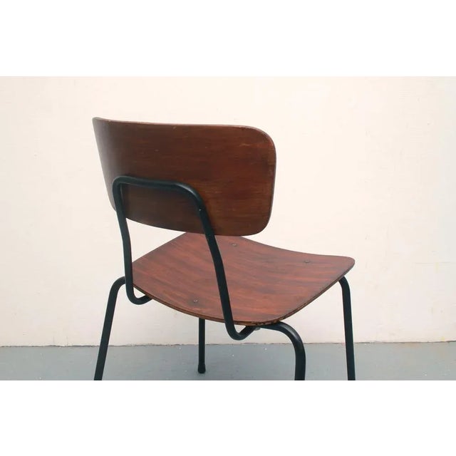 60s layer wood chair. Dark plywood with black metal frame. Simple design in industrial style. with a patina.