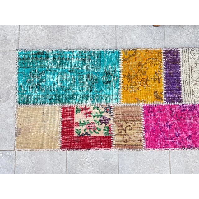 This is a vintage Turkish Oushak rug from the Mid 20th Century. The piece was hand-knotted.