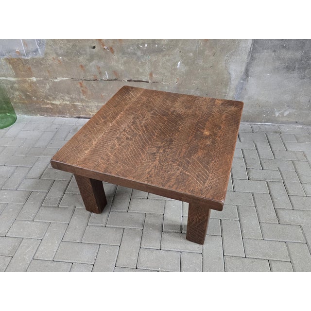 This large and heavy square table is made during the 1970s of solid European oak. The design is simple and elegant, with a...