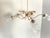French Mid-Century Modern chandelier from the 1960s featuring five curved brass-tone arms, original textured glass shades,...