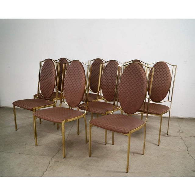 Set of eight vintage Italian dining chairs for sale. These were manufactured in Italy in the 1970's, and have a brass...