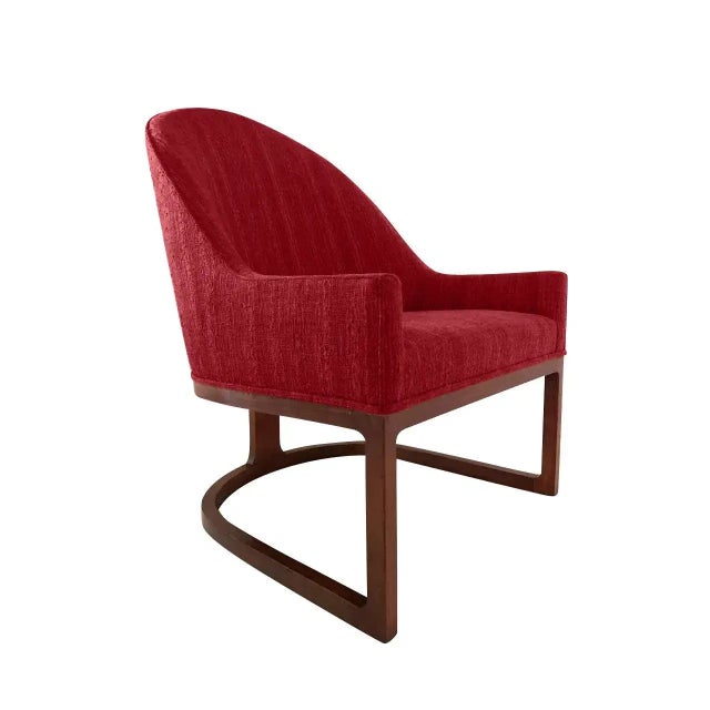 Pair of modern spoonback chairs. The chairs are done in an red chenille. The bases are walnut. The chairs are quite unique...