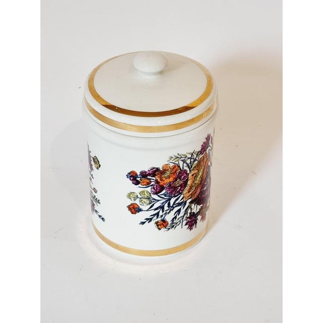 Porcelain jar from the bathroom series by Piero Fornasetti, mid-1900s. With decor of flowers and "Cotton". Signed...
