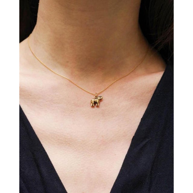 Elephant lucky charm pendant in 10 karat gold. The pendant depicts a trumpeting elephant. In some cultures, the elephant...