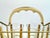 A stylish mid-century cocktail set featuring eight coordinating glasses displayed in their original gold-tone metal...