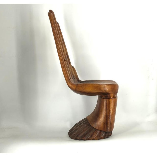 Vintage solid wood sculpted hand shaped side chair. Very eye catching chair which is also very decorative and can be used...