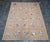 This mid-century French Aubusson rug, dating to the 1950s, features a beautifully structured panel design composed of...
