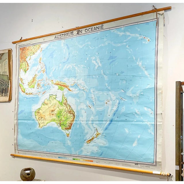This large wall map was printed in Germany in 1961 and is mounted on linen on a simple wooden dowel frame with leather...
