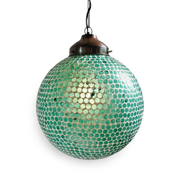 Blue mosaic globe pendant lantern. Hand crafted in India with beautiful blue mosaic glass. Includes 3' chain and ceiling...