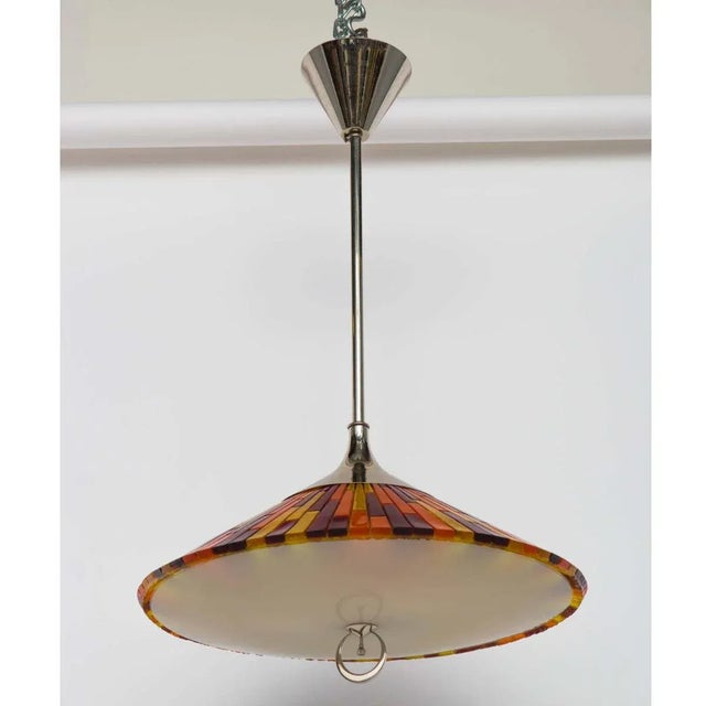 Colorful Acrylic and Glass Pendant with Polished Nickel Hardware. Ornamental metal ring contains an on/off switch