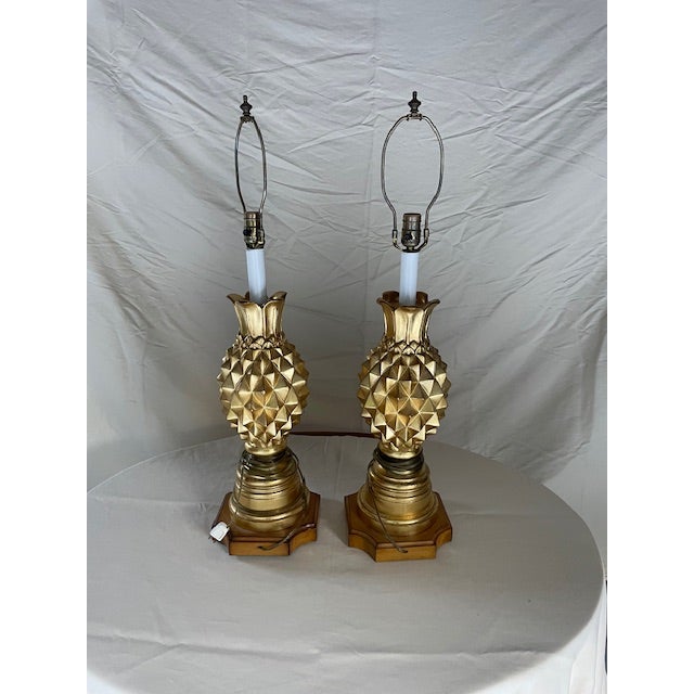 Pair of Gold Pineapple Table Lamps. These are substantial lamps given their size and weight. The gold color adds an...