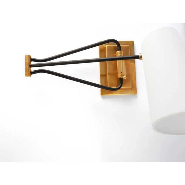 Keil Swing Arm Wall Light in Hand-Rubbed Antique Brass and Black with Linen Shade Designer: AERIN Height: 10" Extension:...