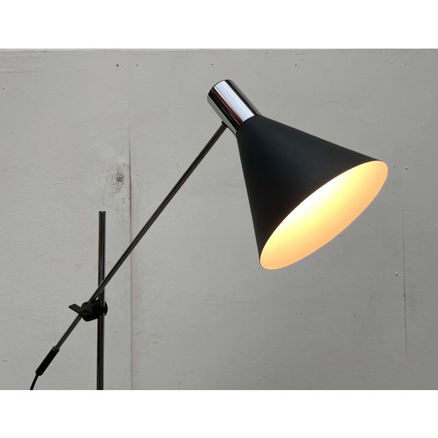 Minimalist mid-century floor lamp. A simple design with a minimalist aesthetic. The lamp head features a classic conical...