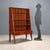 A 20th-century Italian-made piece of furniture with mahogany veneer, featuring three open shelves and two drawers with...