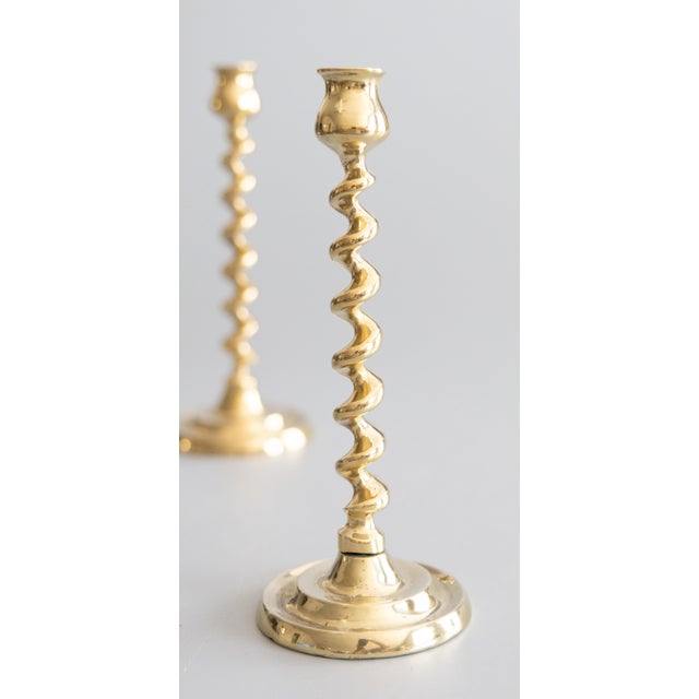 A fine pair of antique English barley twist cast brass candlesticks candle holders, circa 1920. This gorgeous pair are...