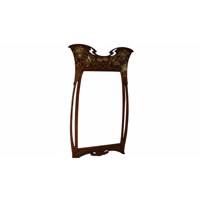 This exceptional Art Nouveau wall mirror (c. 1900-1910) embodies the craftsmanship of the French École de Nancy. Made of...