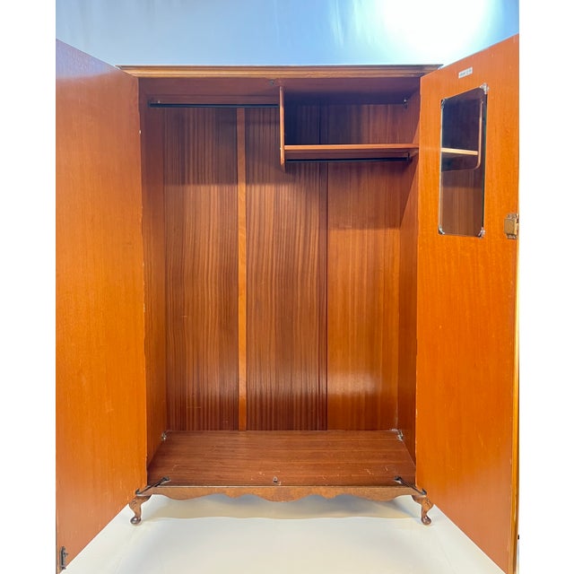 Mid-20th-century burl wardrobe by the prestigious maker Hunters of Derby Ltd. Founded in 1928, the historic British...