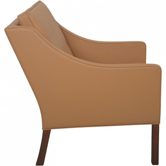 Børge Mogensen 2207 lounge chair upholstered in beige semi anilin leather and with legs of teak. The chair is from around...