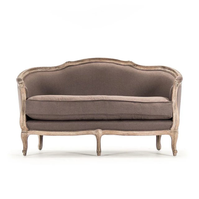 Curved back settee upholstered in aubergine linen on limed grey oak frame.