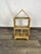 Indian Rosewood Bookcase A wooden shelf in the shape of a house with three levels and two compartments on the lower shelf....