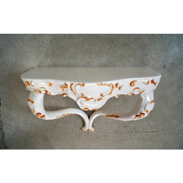Vintage Italian wall mounting shelf for sale. It's in excellent condition, and is made of ceramic. It's white with hand...