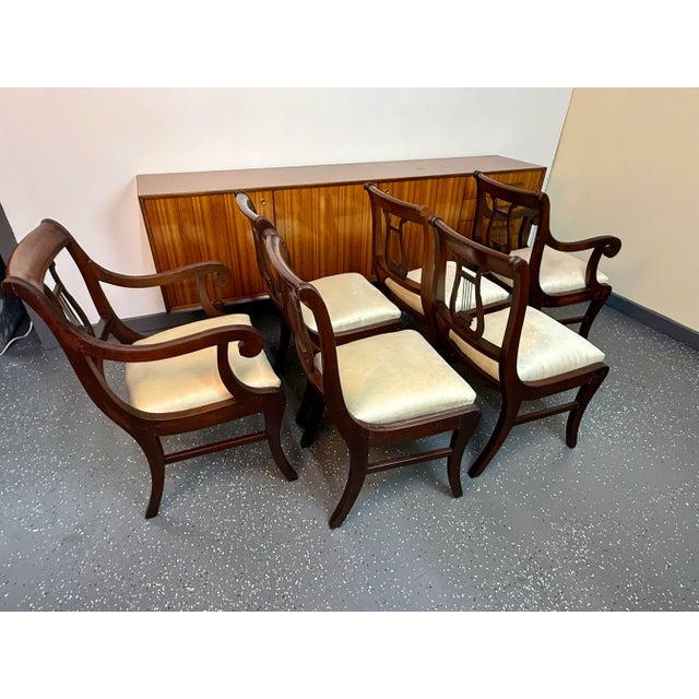 Beautiful vintage set of 1940’s mahogany kilsmos lyre back dining chairs. The set comes with four side chairs and two arm...