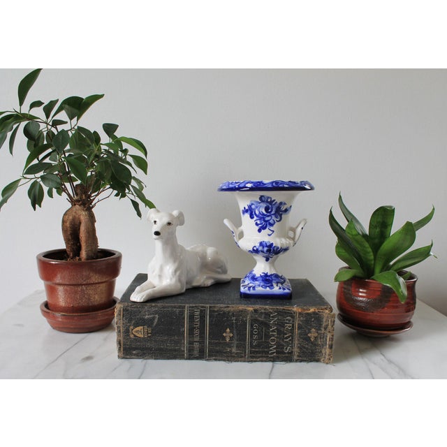Petite blue and white ceramic urn-shaped vase. Made in Portugal. Minor age wear. No chips or cracks. Maker mark on bottom.