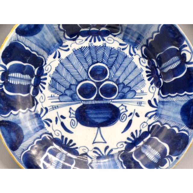 Dutch Delftware blue and white 'Peacock' plate, It is circa late 18th Century It is hand painted with an ochre rim, the...